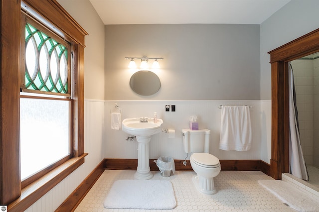 bathroom with curtained shower and toilet