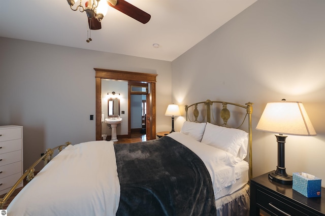 bedroom featuring ensuite bath, ceiling fan, vaulted ceiling, and hardwood / wood-style flooring