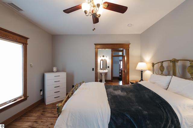 bedroom featuring ceiling fan, light hardwood / wood-style floors, and ensuite bathroom