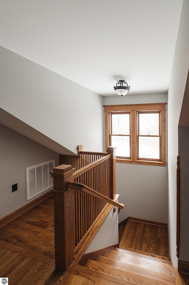 stairs with hardwood / wood-style floors