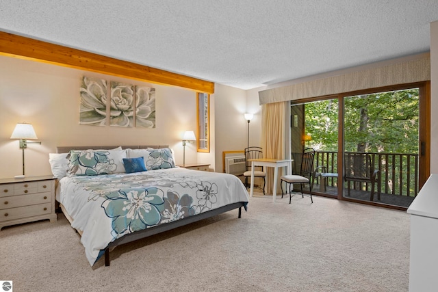 carpeted bedroom featuring a textured ceiling, access to outside, and an AC wall unit