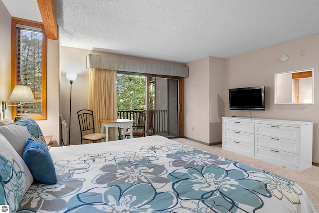 bedroom featuring light carpet, a textured ceiling, and access to outside