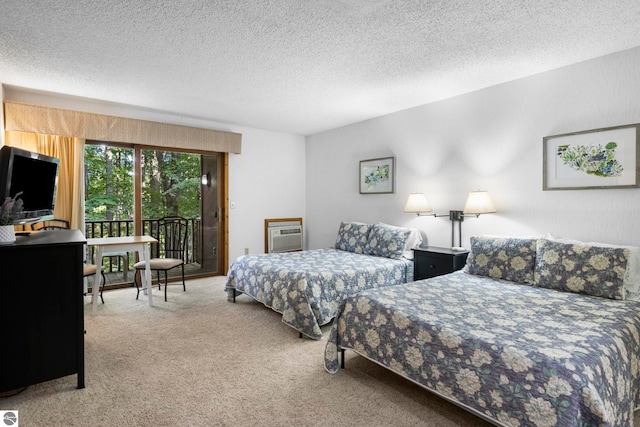 bedroom featuring a textured ceiling, access to outside, and carpet