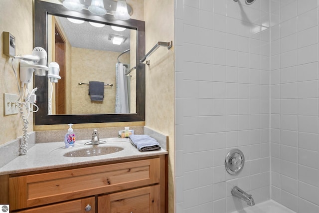 bathroom with vanity, a textured ceiling, and shower / tub combo with curtain