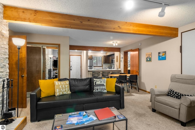 carpeted living room with beamed ceiling and a textured ceiling