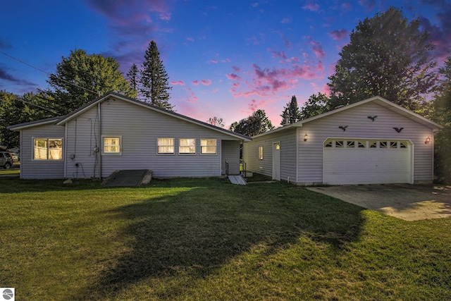 ranch-style home with a yard and a garage