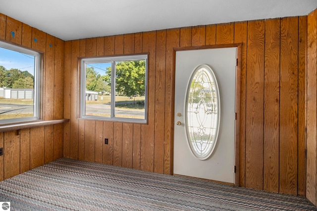 entrance foyer featuring wood walls