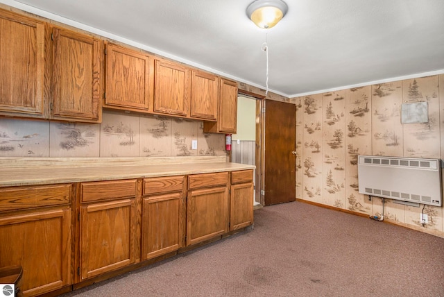 kitchen featuring heating unit and carpet flooring