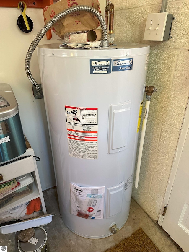 utility room featuring electric water heater