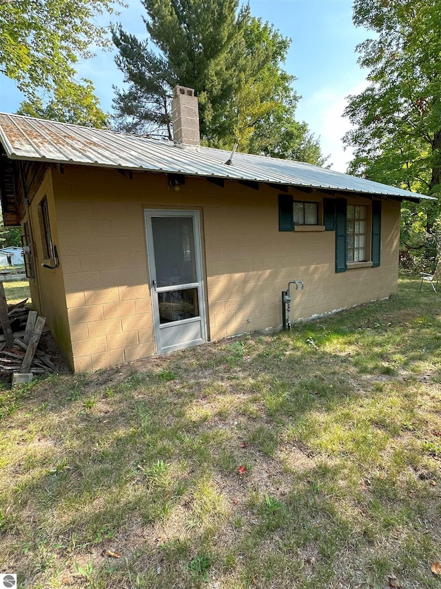 view of side of home featuring a lawn