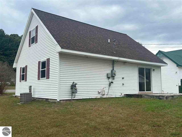 back of property featuring a lawn and central AC unit