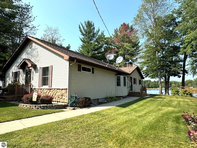 view of side of home with a yard