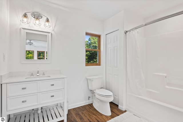 full bathroom with shower / bath combo, hardwood / wood-style flooring, ceiling fan, vanity, and toilet