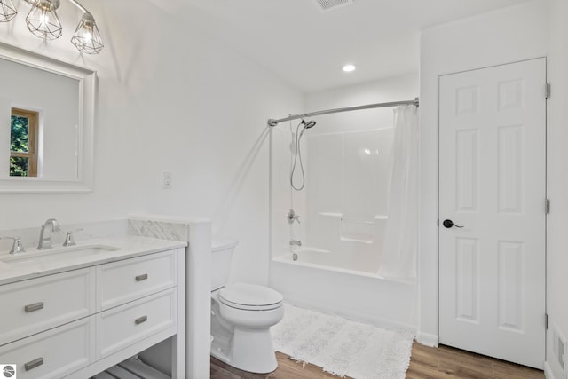 full bathroom featuring shower / tub combo with curtain, vanity, toilet, and hardwood / wood-style flooring