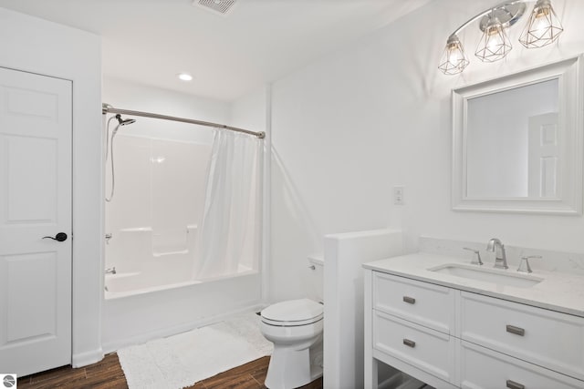 full bathroom with vanity, toilet, shower / bathtub combination with curtain, and hardwood / wood-style flooring