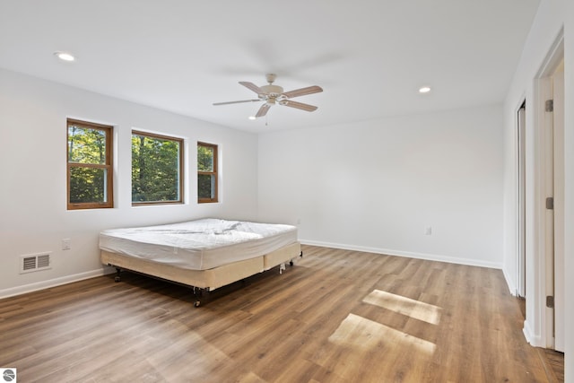 unfurnished bedroom featuring light hardwood / wood-style flooring and ceiling fan