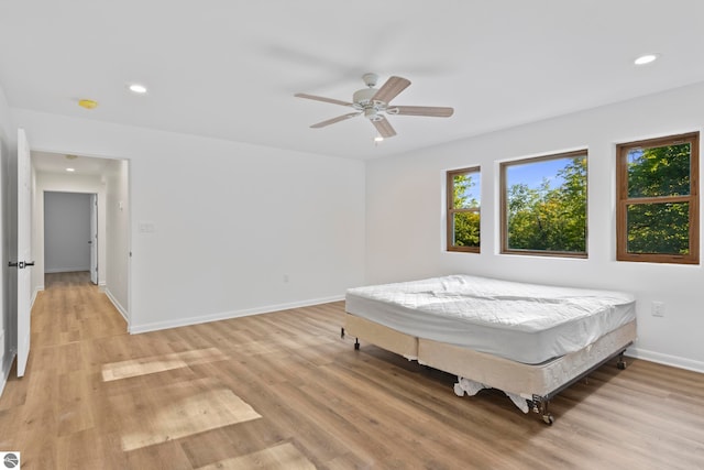 bedroom with light wood-type flooring and ceiling fan