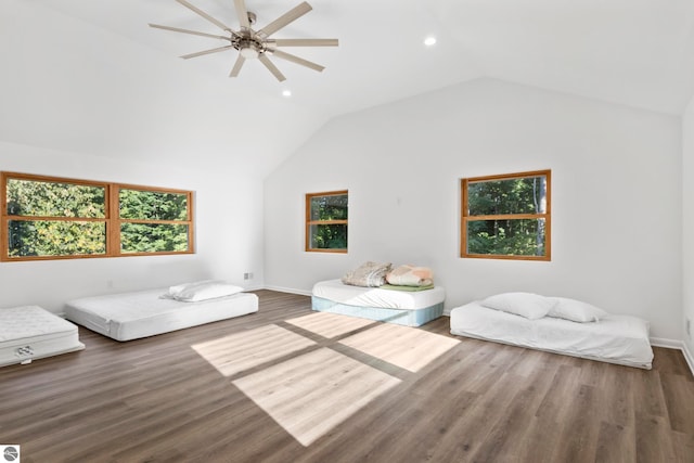 interior space with ceiling fan, vaulted ceiling, and dark wood-type flooring