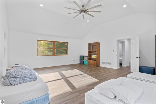 bedroom featuring hardwood / wood-style floors, ceiling fan, and high vaulted ceiling