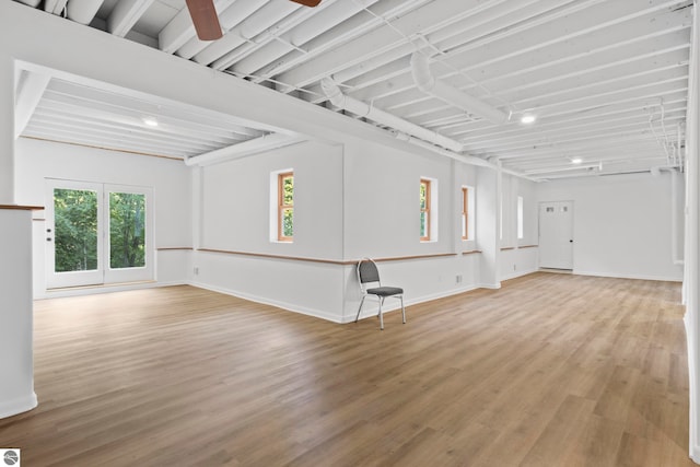 unfurnished living room featuring ceiling fan and hardwood / wood-style flooring