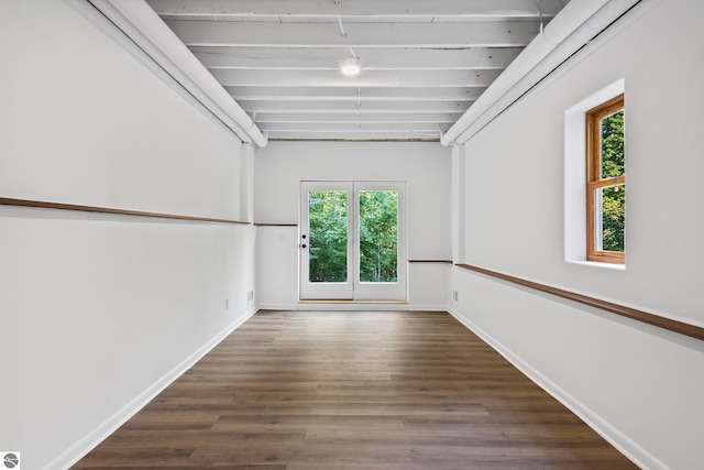 unfurnished room featuring dark hardwood / wood-style flooring and a wealth of natural light