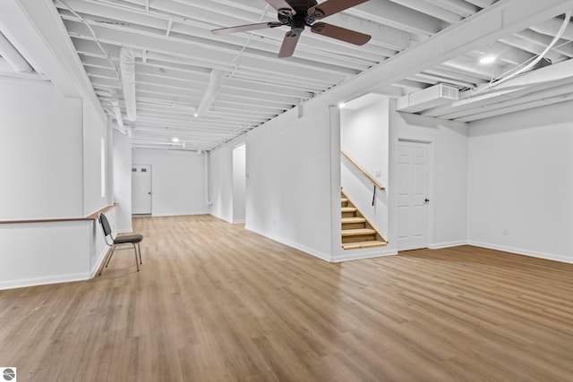 basement with wood-type flooring and ceiling fan