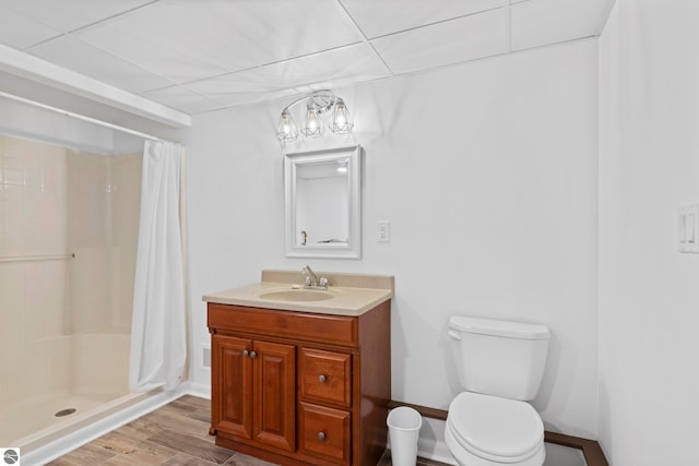 bathroom featuring vanity, hardwood / wood-style flooring, toilet, and a shower with shower curtain