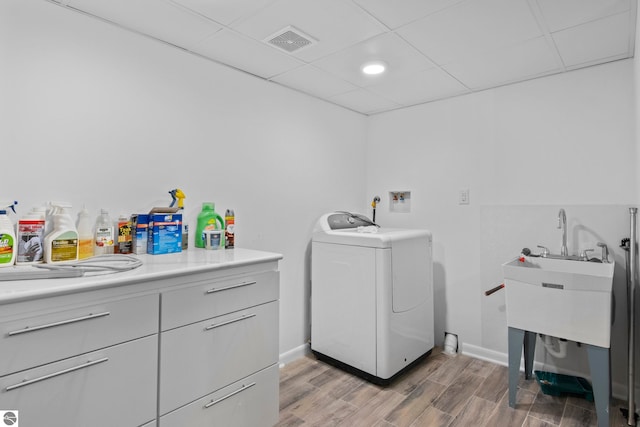 laundry room featuring wood-type flooring and washer / dryer