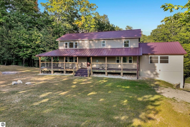 view of front of house with a front yard and a wooden deck