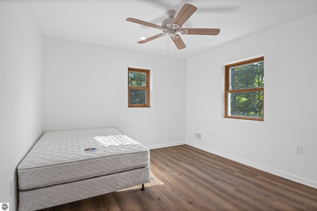 bedroom featuring ceiling fan and dark hardwood / wood-style floors