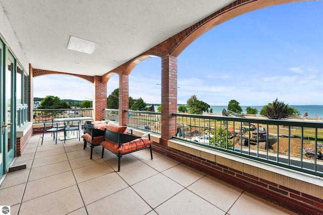 balcony featuring a water view