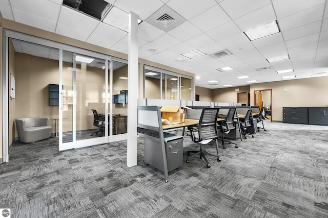 office space featuring dark carpet and a drop ceiling