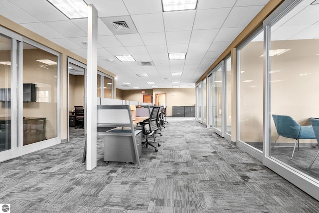 interior space with a paneled ceiling