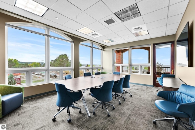 office space with a healthy amount of sunlight, carpet flooring, and a paneled ceiling