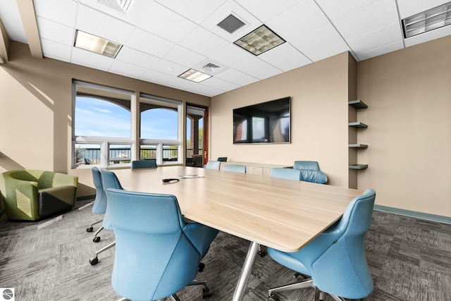 carpeted office space with a drop ceiling