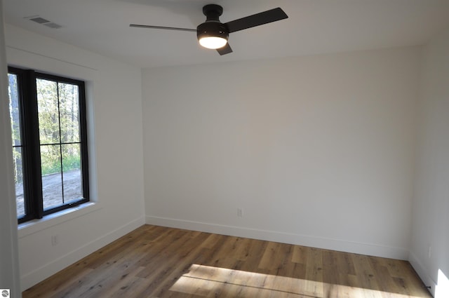 unfurnished room featuring hardwood / wood-style floors and ceiling fan