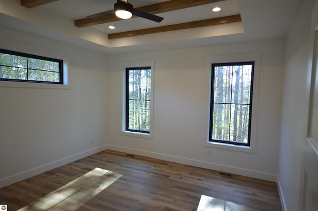 empty room with hardwood / wood-style floors, ceiling fan, and beam ceiling