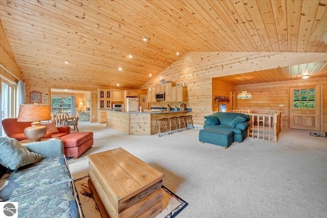 carpeted living room with lofted ceiling, wood ceiling, and wooden walls