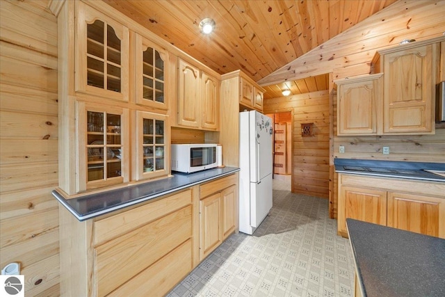 kitchen with light brown cabinets, wood ceiling, lofted ceiling, white appliances, and wooden walls