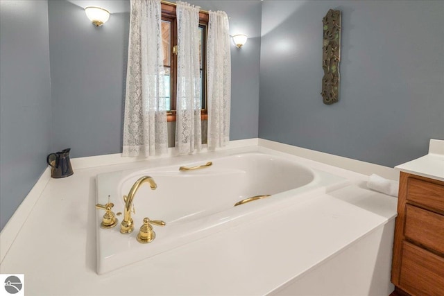 bathroom with a bathing tub and vanity