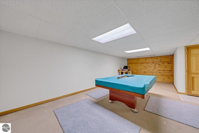 rec room featuring wood walls, concrete floors, a paneled ceiling, and billiards