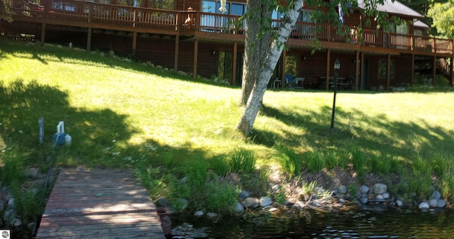 view of yard featuring a deck with water view