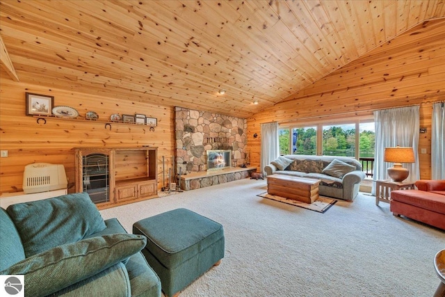 carpeted living room featuring a stone fireplace, wood ceiling, wood walls, and high vaulted ceiling