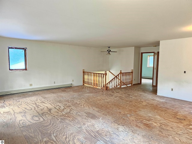 empty room with wood-type flooring and baseboard heating