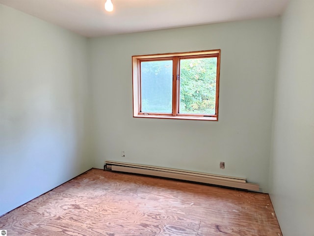 empty room featuring a baseboard heating unit