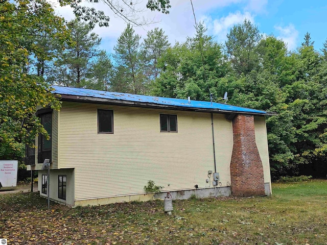 view of side of home featuring a lawn