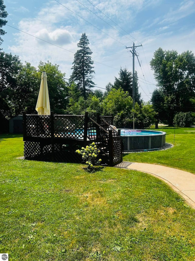 exterior space featuring a pool side deck and a yard