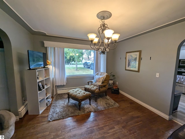 living area with an inviting chandelier, baseboard heating, and dark wood-type flooring