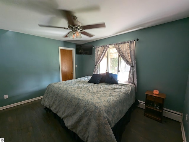 bedroom with ceiling fan, dark hardwood / wood-style flooring, and a baseboard heating unit