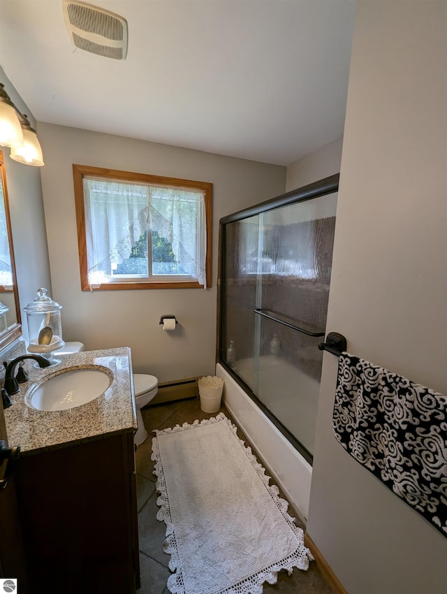 full bathroom with tile patterned flooring, a baseboard radiator, vanity, enclosed tub / shower combo, and toilet